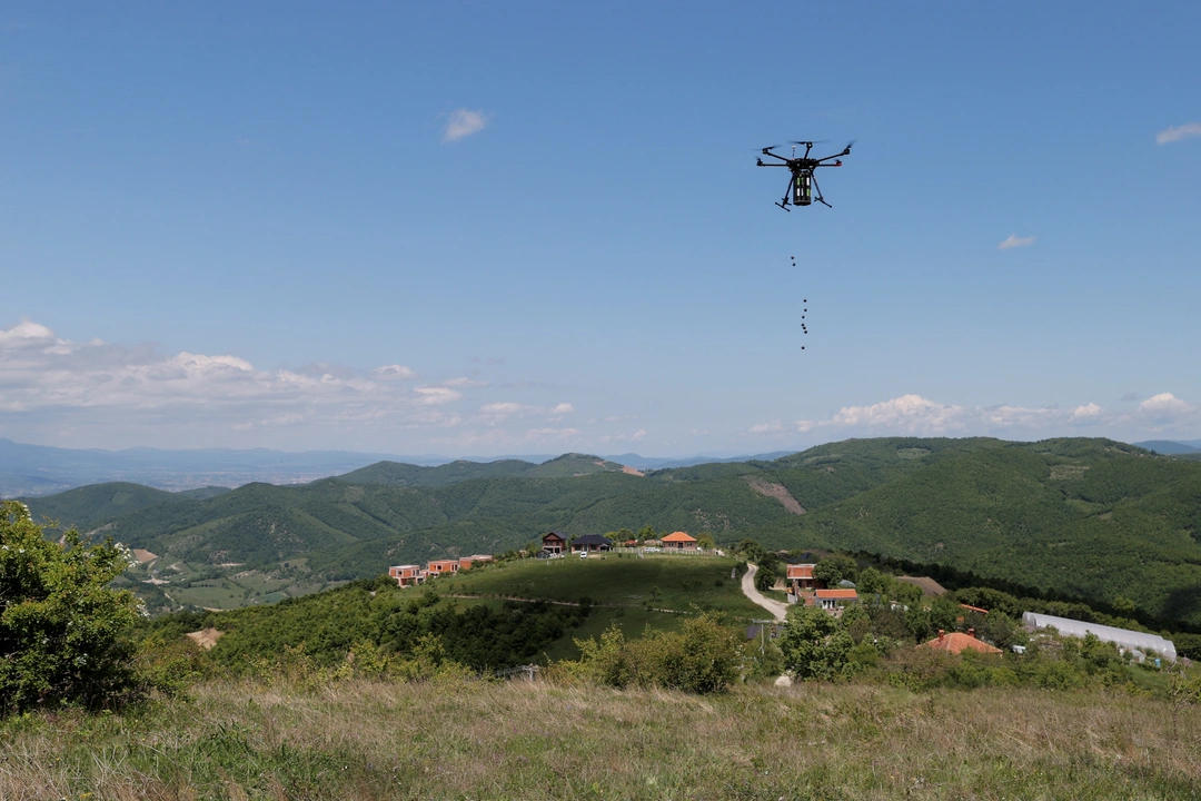 A drone drops seeds over a forested area on the first day of drone reforestation in Butovc, Kosovo May 13, 2024. REUTERS/Valdrin Xhemaj